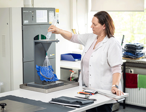 Textile lab technician tests the functionality of fabric